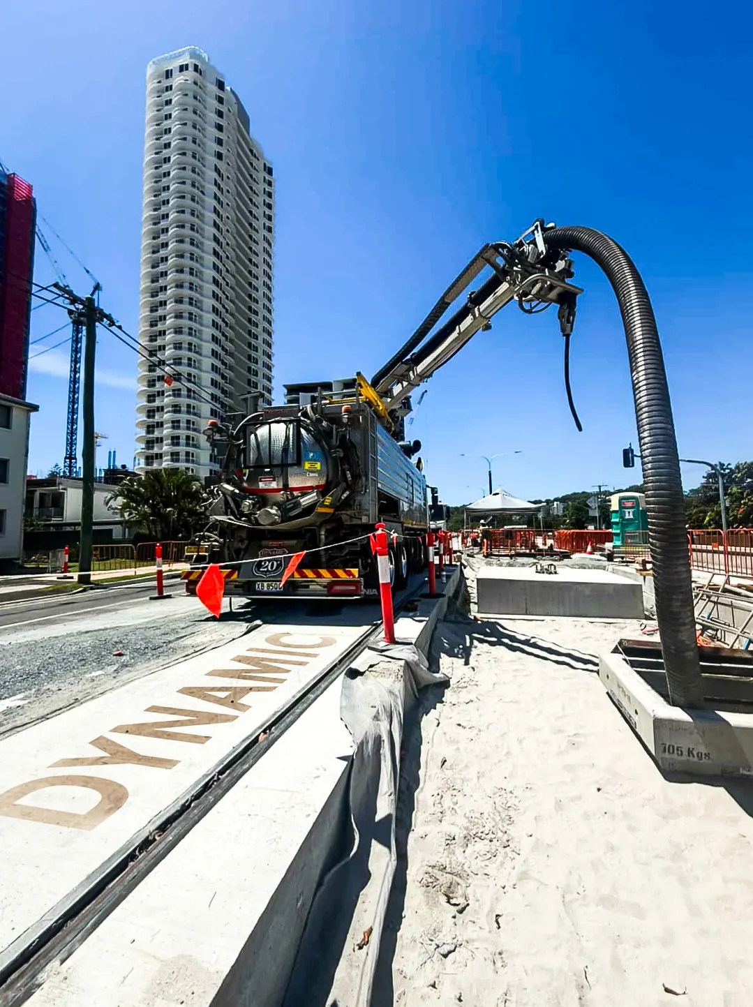 Dynamic combination unit working a stormwater installation on a Gold Coast street with its boom hose extended