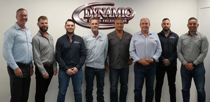 Dynamic Hydro Excavations regional managers standing together in front of the company signage at the annual general meeting